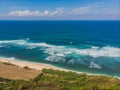 Top aerial view of beauty Bali beach. Empty paradise beach, blue sea waves in Bali island, Indonesia. Suluban and Nyang