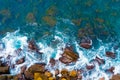 Top aerial view of blue waves crashing on rocky Australian coastline. Royalty Free Stock Photo