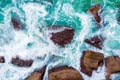 Top aerial view of blue waves crashing on rocky Australian coastline. Royalty Free Stock Photo
