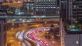 Top aerial view of busy road intersection and traffic junctions in Dubai city night timelapse. Royalty Free Stock Photo