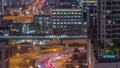 Top aerial view of busy road intersection and traffic junctions in Dubai city night timelapse.