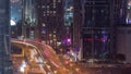 Top aerial view of busy road intersection and traffic junctions in Dubai city night timelapse. Royalty Free Stock Photo