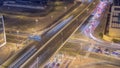 Top aerial view of busy road intersection and traffic junctions in Dubai city night timelapse. Royalty Free Stock Photo