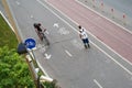 Top aerial view of cyclist and inline skater on cycling road. Royalty Free Stock Photo