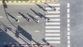 Top aerial view of group people walk at street city with pedestrian crosswalk in transport traffic road with sunlight and shadow Royalty Free Stock Photo