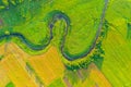 Top aerial view of the natural landscape valley of a meandering river among green fields and forests Royalty Free Stock Photo