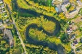 Top aerial view of the natural rural landscape valley of a meandering river among green fields and forests Royalty Free Stock Photo