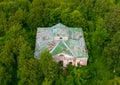 Top aerial view shot of abandoned building in impassable dense green forest. Royalty Free Stock Photo