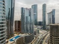 Top aerial view shot of Al Reem island Sun and Sky towers and landmarks in Abu Dhabi city, UAE