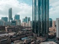 Top aerial view shot of skyscrapers in a modern city with fog clouds passing by - Downtown Abu Dhabi landmarks and World Trade Cen