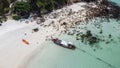 Top, aerial view of white sandy beach with rocks and crystal clear sea water. Long tail boat and kayaks on the coast. Summer on Royalty Free Stock Photo