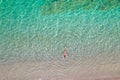 Top, aerial view. Young beautiful woman in a red bikini panties swimming in sea water on the sand beach. Drone, copter photo. Royalty Free Stock Photo