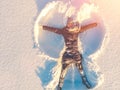 Top aerial view of young happy smiling girl making by arms snow angel figure and lying in snow, winter outdoor activity Royalty Free Stock Photo