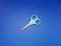 A top angel of an old scissor with a curved tip so it\'s safe for children, with a bright blue handle
