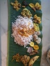 Top angle shot of onam sadhya in kerala style with curries in a banana leaf.