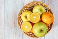 Top angle view on basket with fruit orange lemon and apples on table Royalty Free Stock Photo