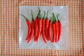 Top angle view of group of fresh red chillies, drying on kitchen towel, dish cloth after being washed
