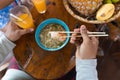 Top Angle View Of Man Eating Noodles Chopstick And Drinking Orange Juice Trying Traditional Asian Food Royalty Free Stock Photo