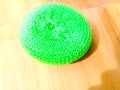 A green plastic scrubber placed on the floor. Royalty Free Stock Photo