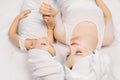 Top angle view of pretty young mother and her little cute daughter wrapped in a towel after a bath, lying together on Royalty Free Stock Photo