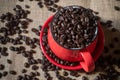 Top angle view of red coffee cup full of coffee beans Royalty Free Stock Photo