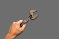 Top angle of a young man holding adjustable wrench Royalty Free Stock Photo