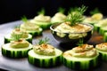 top an arrangement of cucumber slices with hummus using spoon Royalty Free Stock Photo