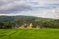 Green field with Wat Sri Pho Chai, background of mountains and blue sky in Na Haeo, Loei, Thailand