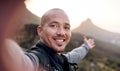 The top is a beautiful place. Cropped portrait of a handsome young man taking selfies while hiking in the mountains. Royalty Free Stock Photo