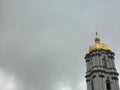 Top of bell tower against grey rainy sky Royalty Free Stock Photo