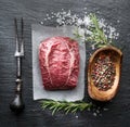 The top blade steak or beef steak on the graphite board with herbs and spices Royalty Free Stock Photo