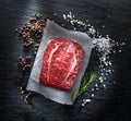 The top blade steak or beef steak on the graphite board with herbs and spices Royalty Free Stock Photo