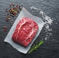 The top blade steak or beef steak on the graphite board with herbs and spices Royalty Free Stock Photo