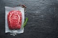 The top blade steak or beef steak on the graphite board with herbs and spices Royalty Free Stock Photo