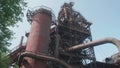 Top of blast furnace of abandoned metallurgic plant. Rusted metal constructions. Counter light.