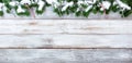 Snowy Christmas evergreen branches and candy canes on white vintage wooden planks Royalty Free Stock Photo