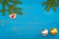 At the top of the branches were spruce with a Christmas tree toy. At the bottom there are two balls of gold and silver color. Blue Royalty Free Stock Photo