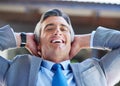 On top of the business world. a content businessman leaning back in his chair with his hands behind his head. Royalty Free Stock Photo