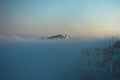 Top of Caldera cliff above the fog at sunny sunrise, village of Imerovigli, Santorini island