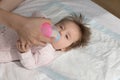 Newborn lying on bed drink breast milk from bottle
