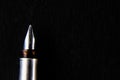 Top close up shot of one fountain pen nib in focus shot over black background -knowledge concept Royalty Free Stock Photo