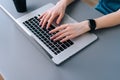 Top close-up view of hands of unrecognizable business woman typing on laptop keyboard sitting at desk Royalty Free Stock Photo