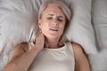 Above lying middle-aged woman feeling pain in neck Royalty Free Stock Photo