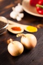 Top close up view on onions with different vegetables blurred on