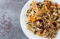 Top close view of chicken with pecans and wild rice on a plate atop a gray background Royalty Free Stock Photo