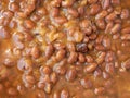 Top close view of a serving of baked beans and onions illuminated with natural lighting