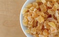 Top close view of a small bowl filled with dried diced peaches Royalty Free Stock Photo