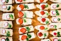 Top closeup of mini snacks with vegetables and fruits on the wooden background