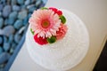 Top closeup shot of a beautiful white wedding cake decorated with colorful flowers Royalty Free Stock Photo