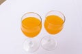 Top closeup of two glasses of orange juice on the white background Royalty Free Stock Photo